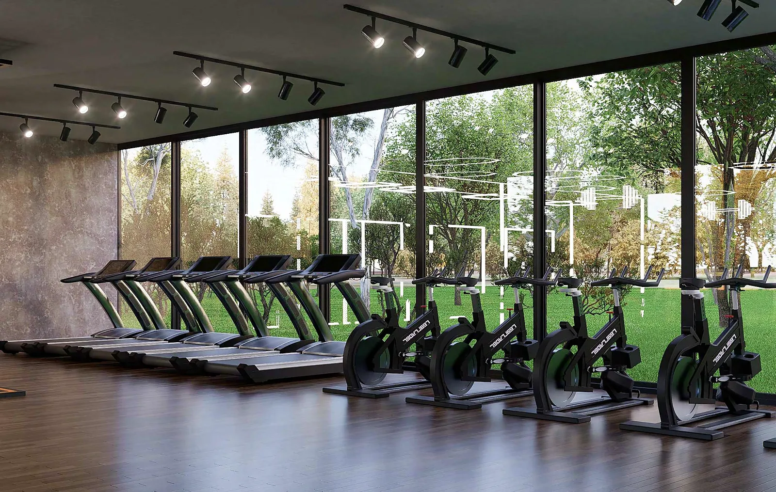 Gimnasio con cintas y bicicletas frente a ventanales con vista a las áreas verdes